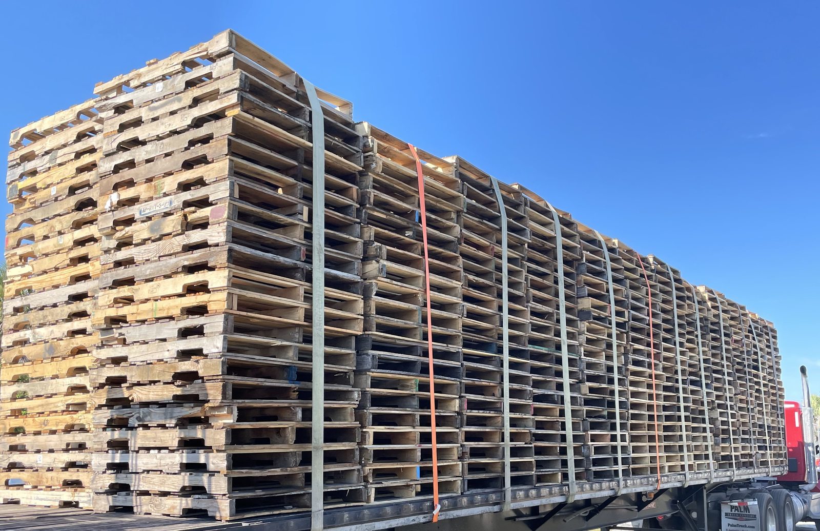 Flatbed truck loaded with pallets ready for Florida delivery