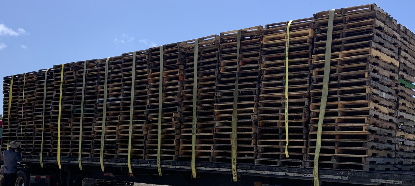 Full flatbed load of pallets strapped and ready for Florida delivery