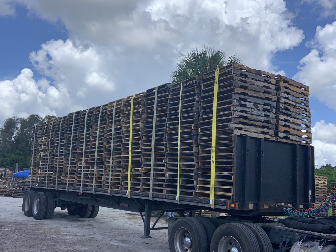 Flatbed Landoll trailer loaded with pallets