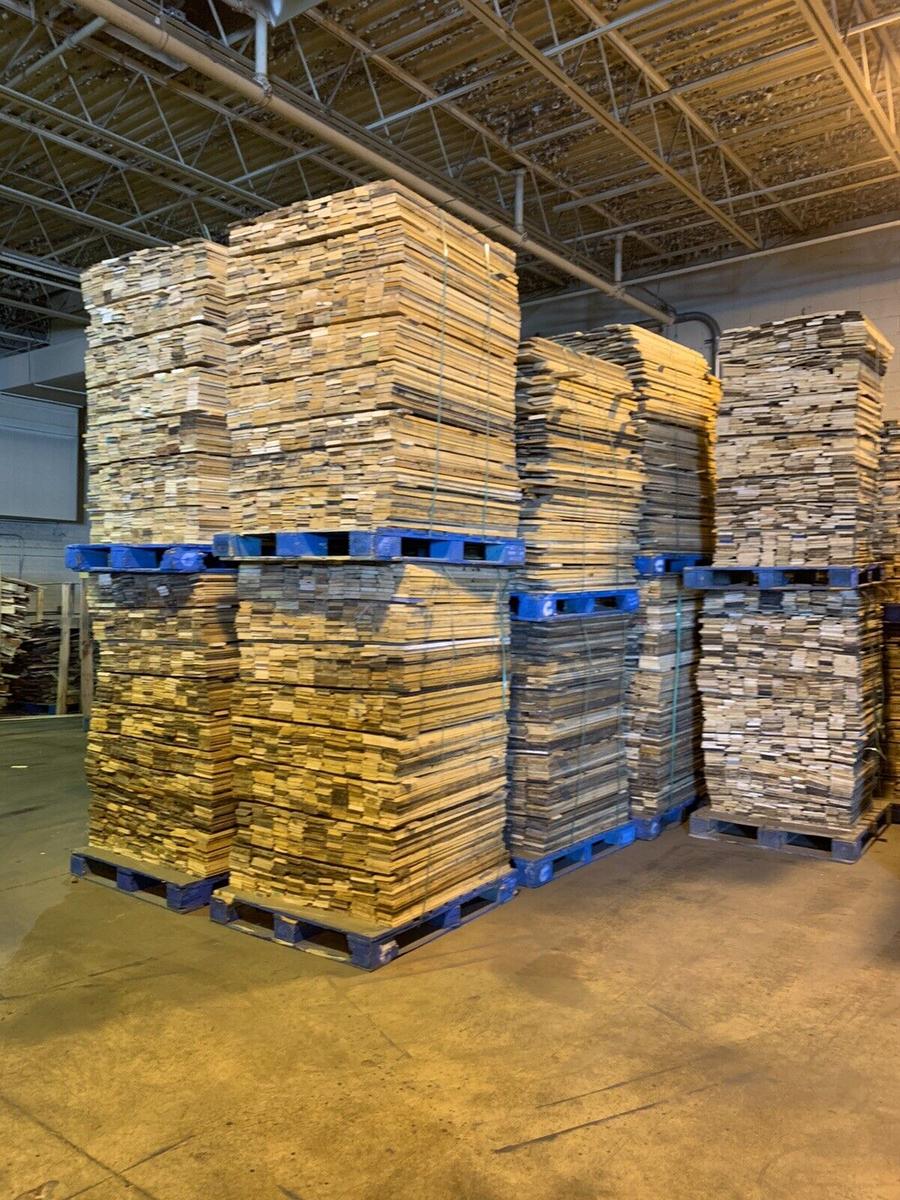 Pallet lumber boards stacked on blue pallets in warehouse for manufacturing