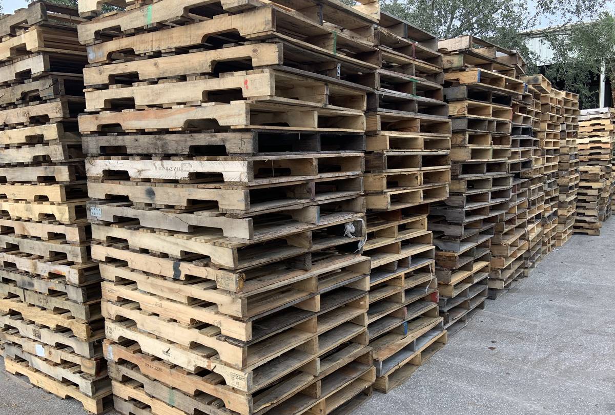Large bulk inventory of recycled GMA pallets at Florida pallet supplier