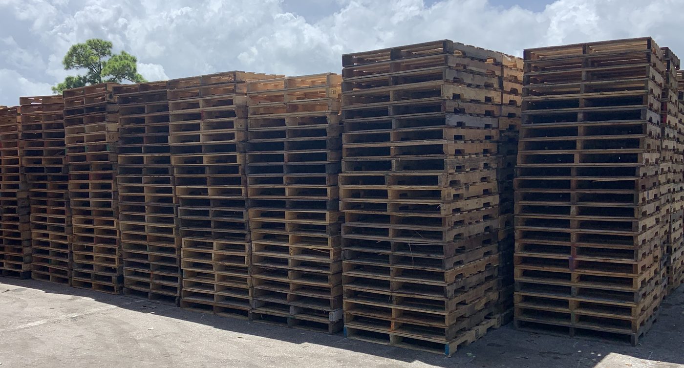 Large outdoor inventory of recycled GMA 48x40 pallets at Florida pallet supplier